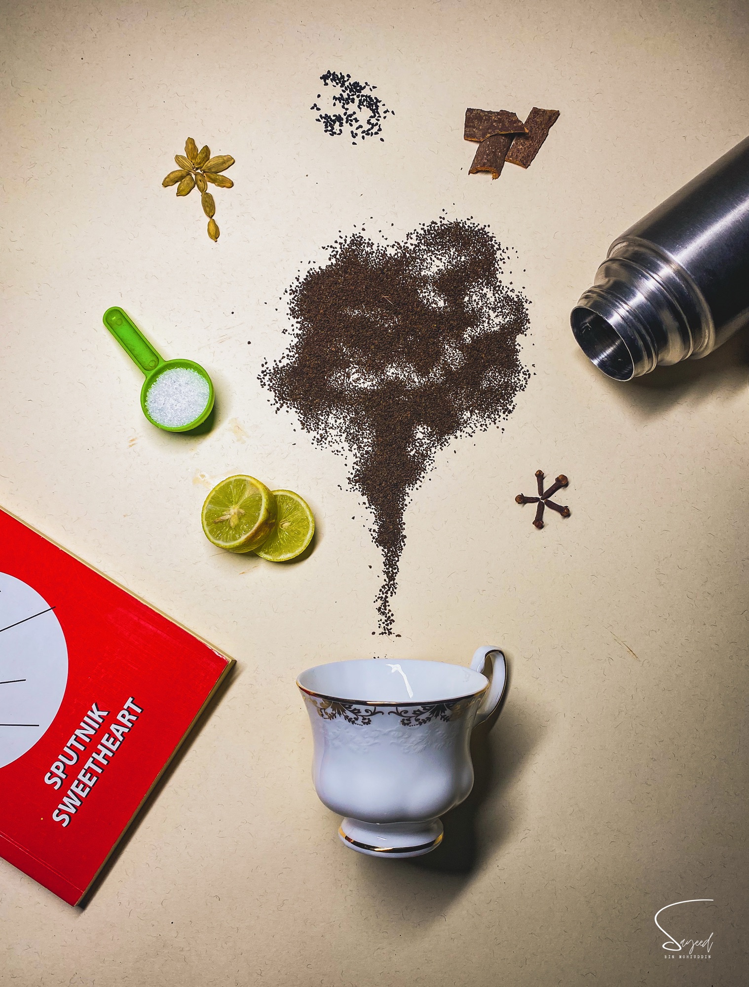 Macro shot of lime wedges and dark spice powder scattered on a table