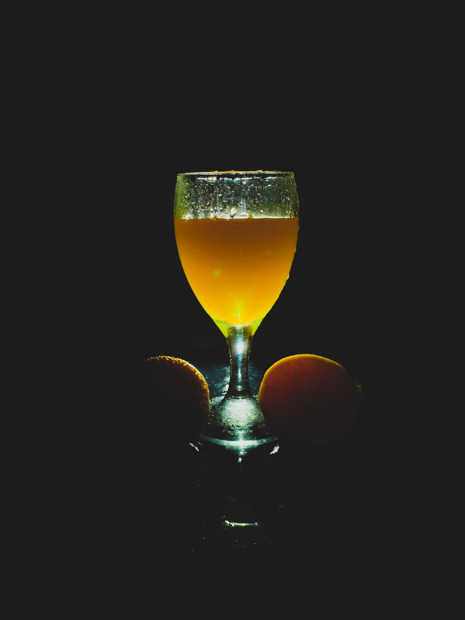 Glass of craft beer glowing against a dark moody background