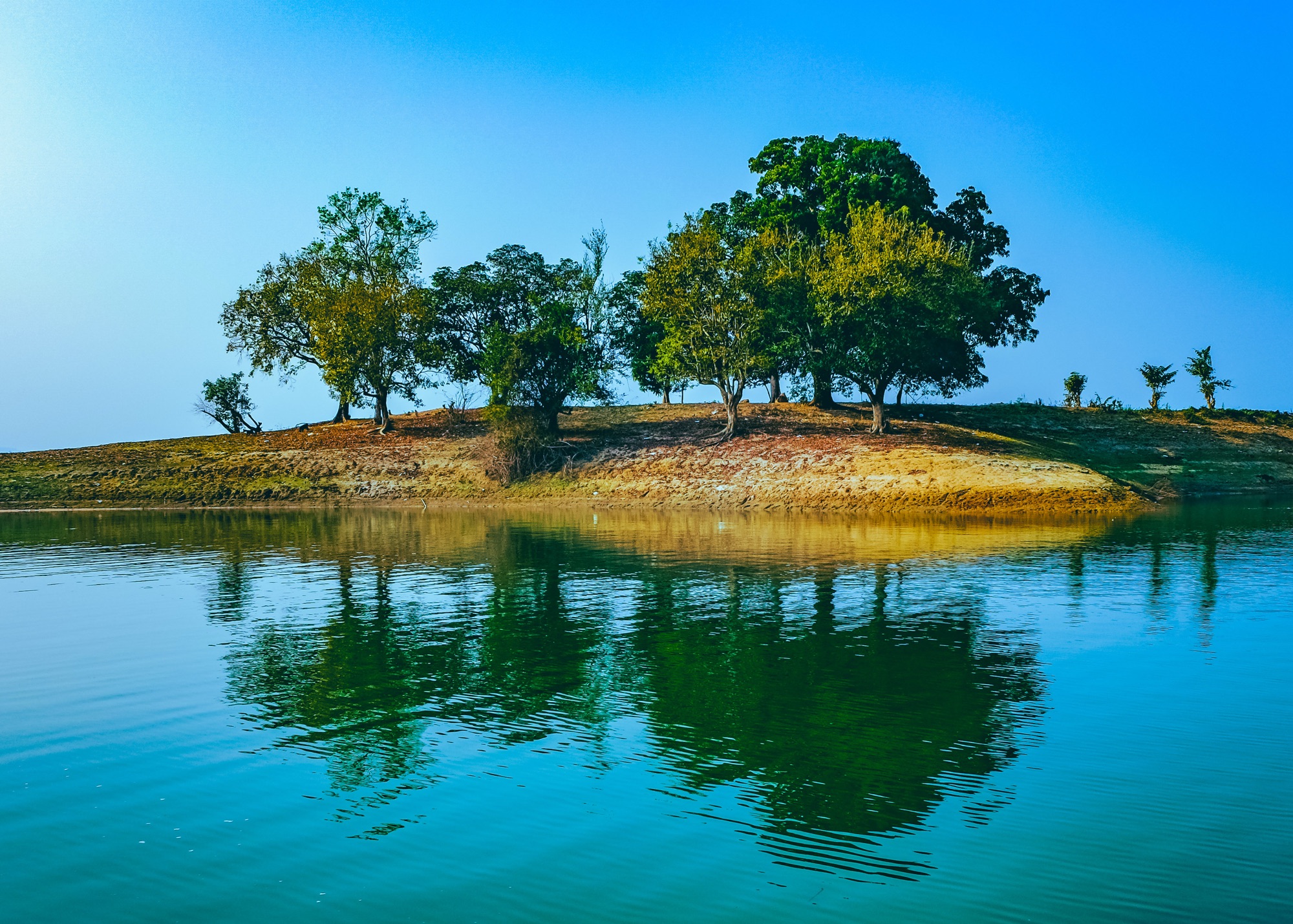 An isolated island on the still water of the lake, Rangamati, Bangladesh