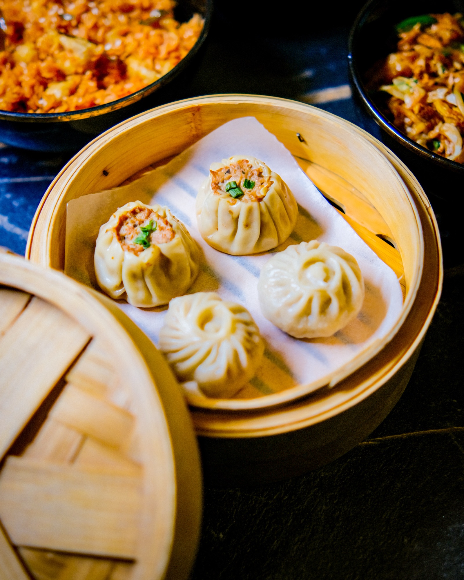 Bamboo steamer basket of dumplings, overhead detail shot