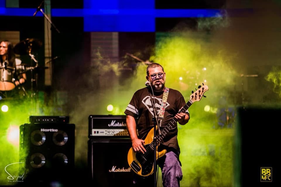 Performer on stage under colorful stage light at a Shironamhin concert in Dhaka — Sayeed BM