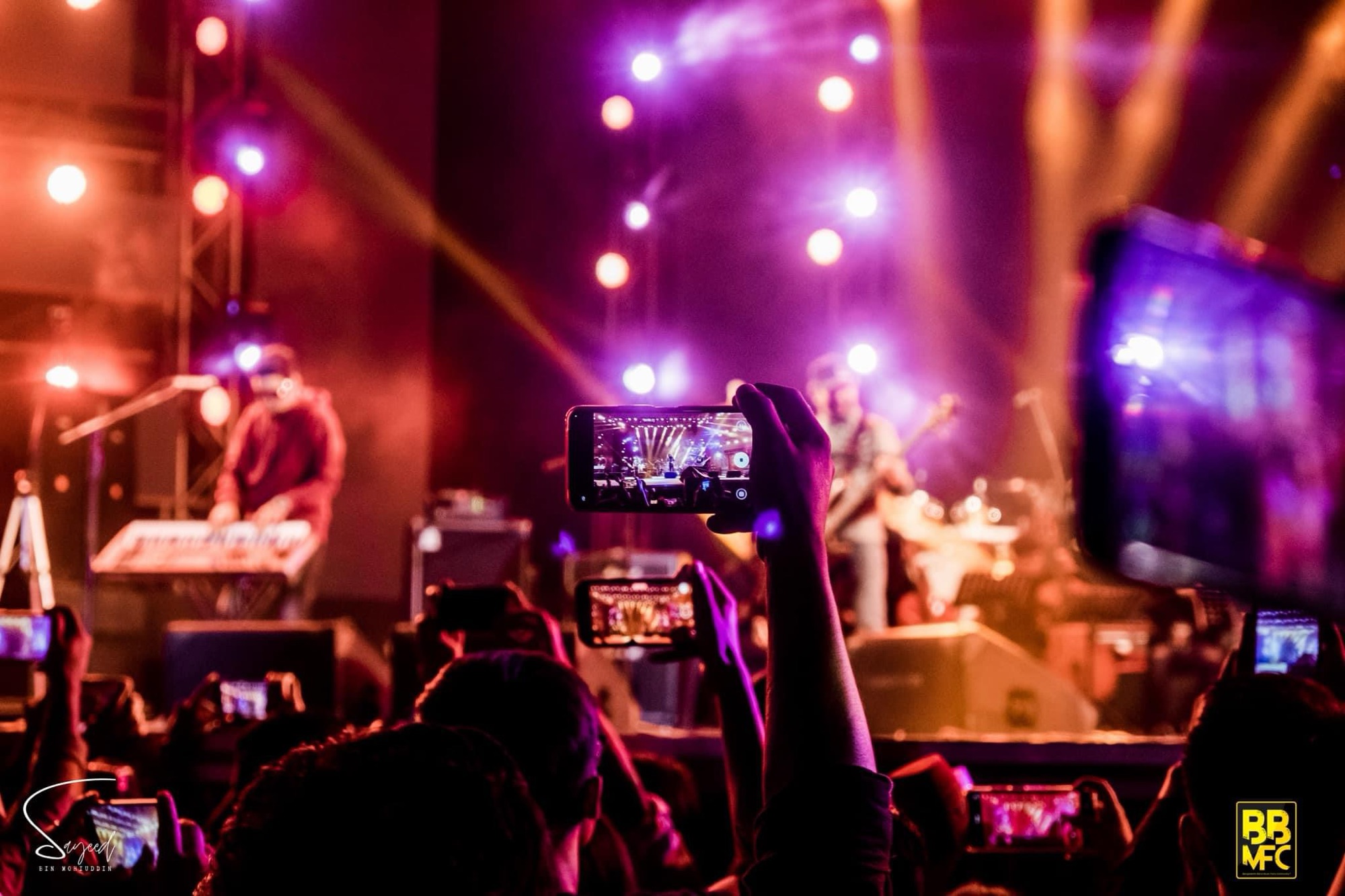 Crowd watching the show, hands raised, at a Shironamhin concert in Dhaka — Sayeed BM