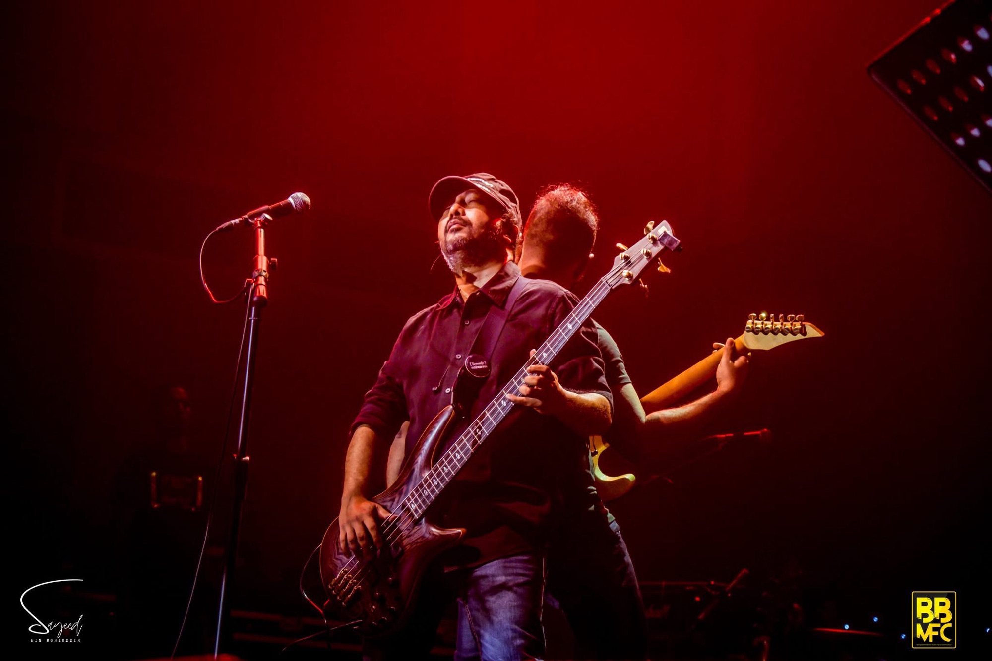 Performer on stage under stage light at a Shironamhin concert in Dhaka — Sayeed BM