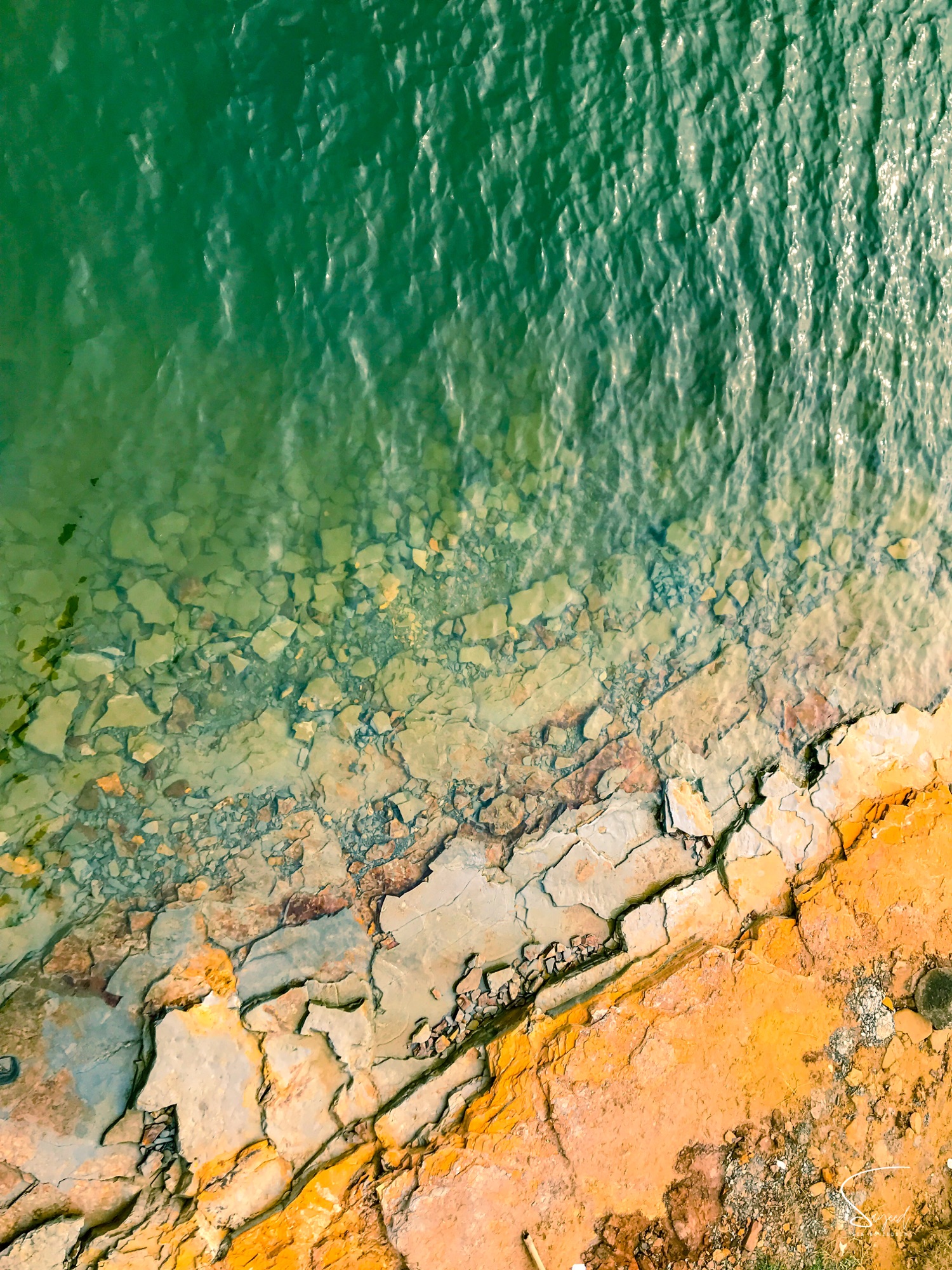 Earthy texture of lake water, soil and stones, Rangamati