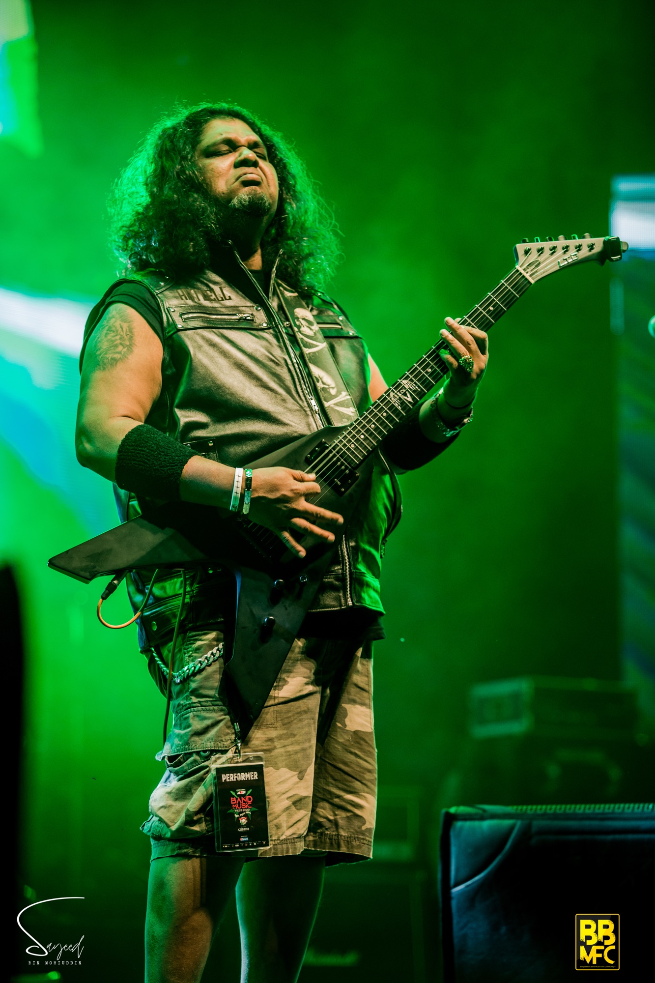 Performer under dramatic stage lighting at a live concert in Dhaka — Sayeed BM