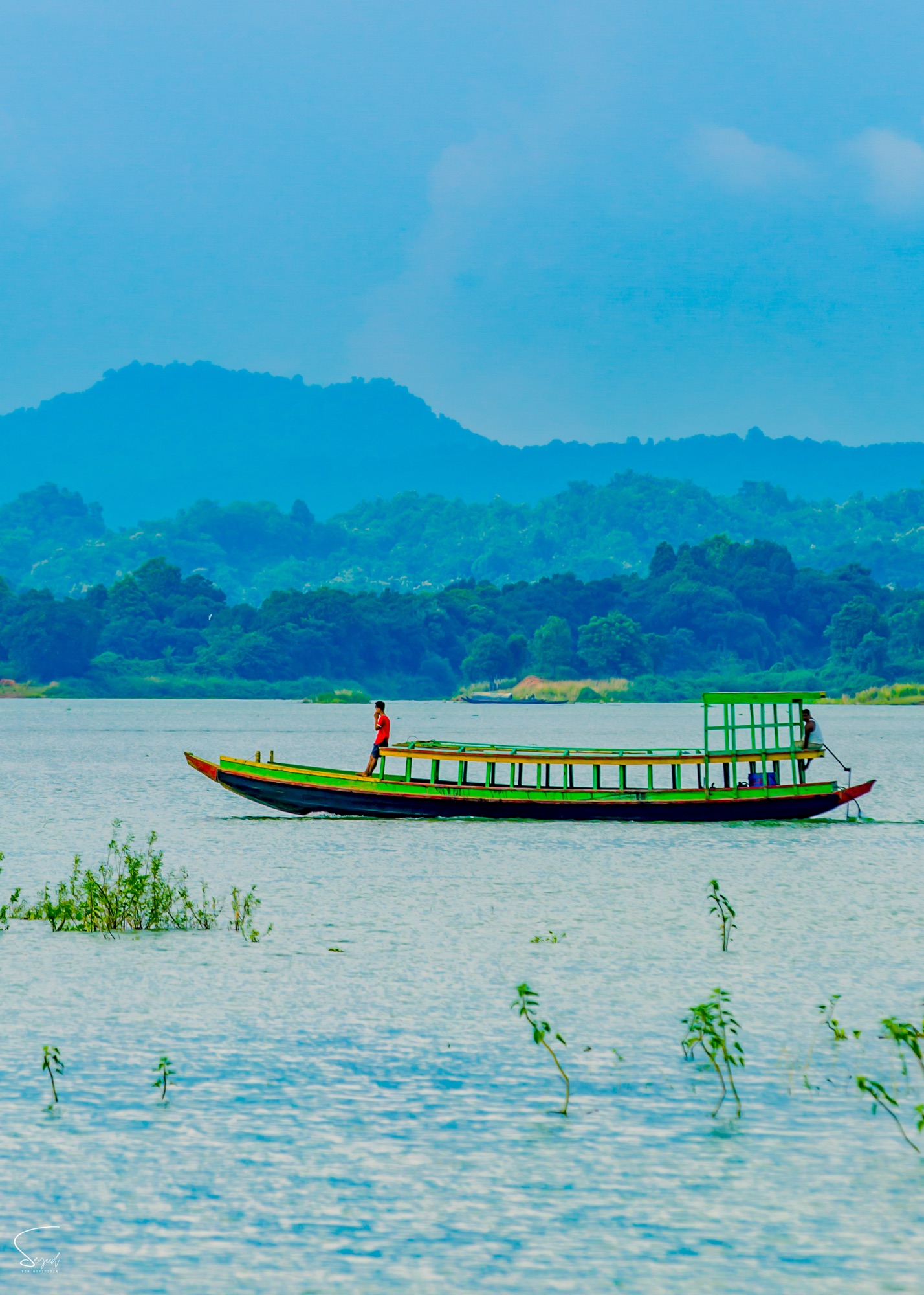 An empty passenger boat sailing the lake, Rangamati