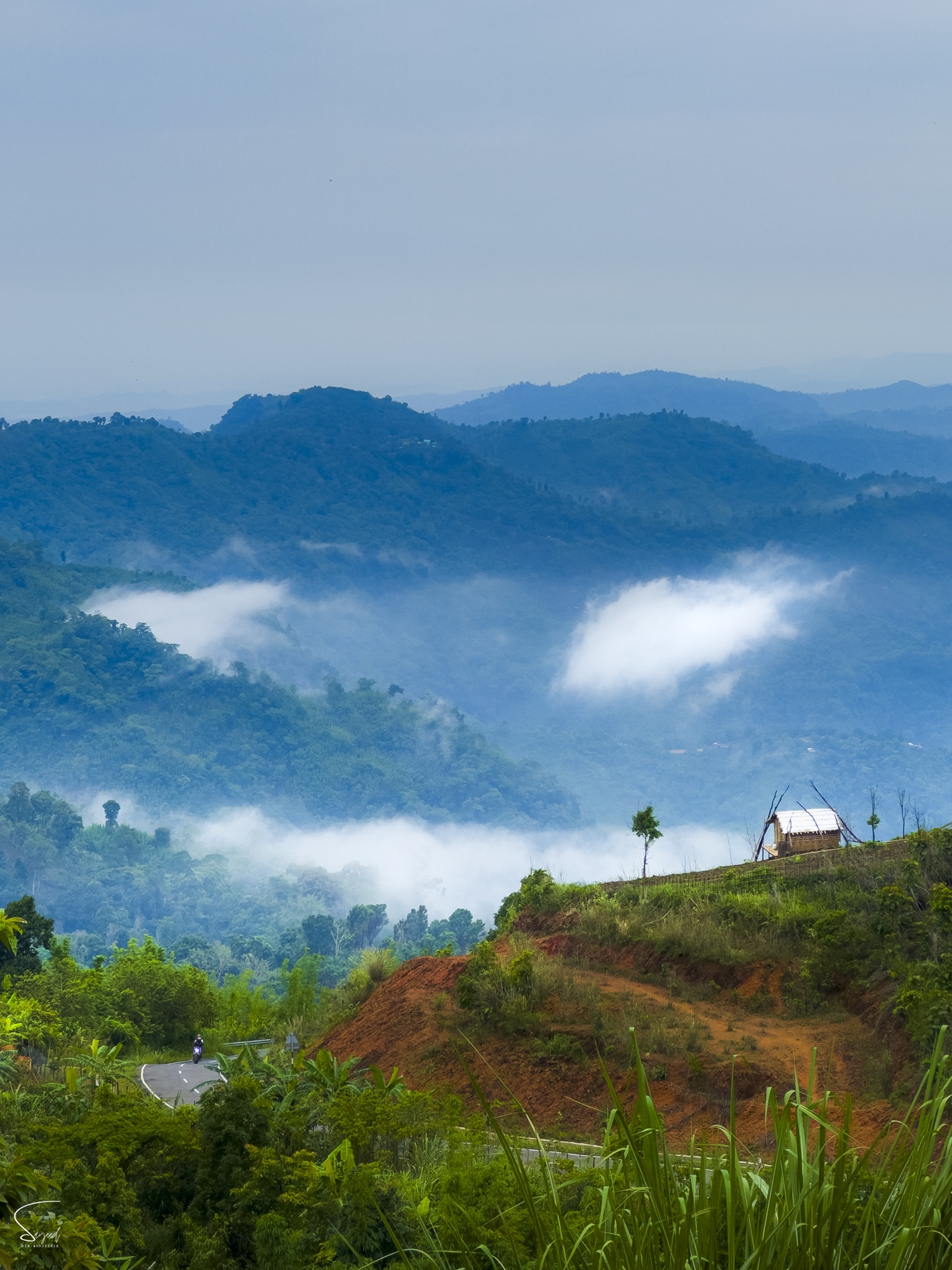 Layered blue mountains with cloud rolling through the valley, Bandarban, Bangladesh