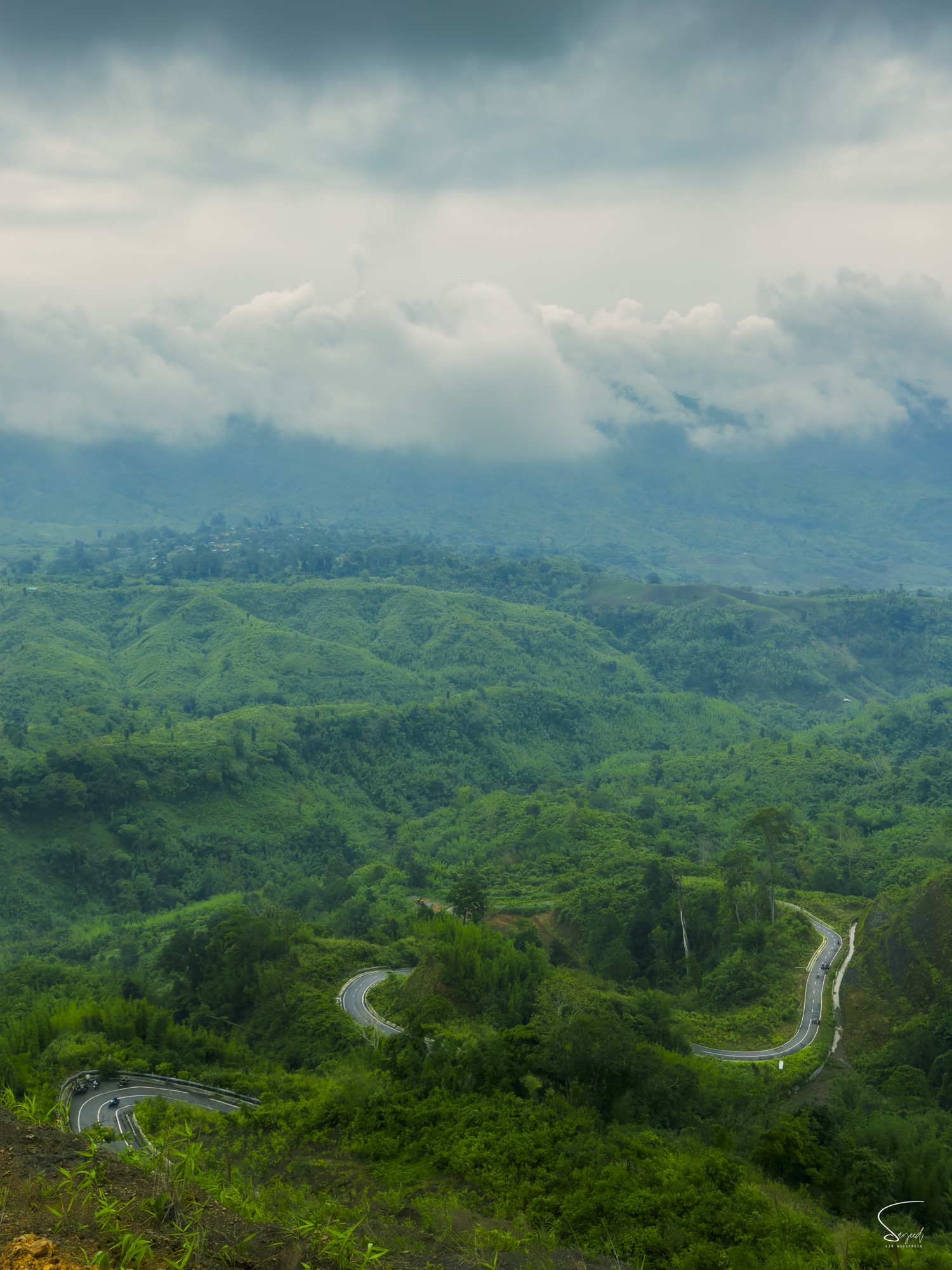 A hill road winding through green hills, Bandarban